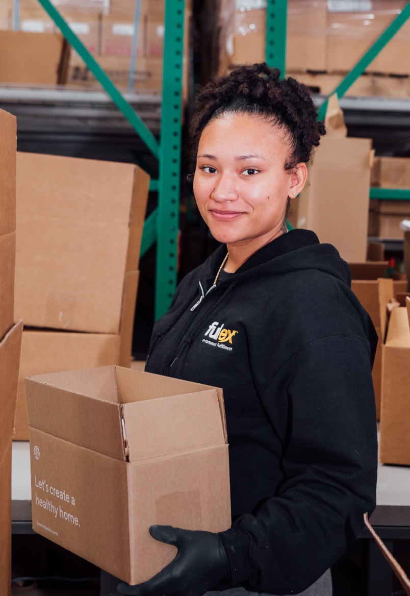 Girl smiling holding a box