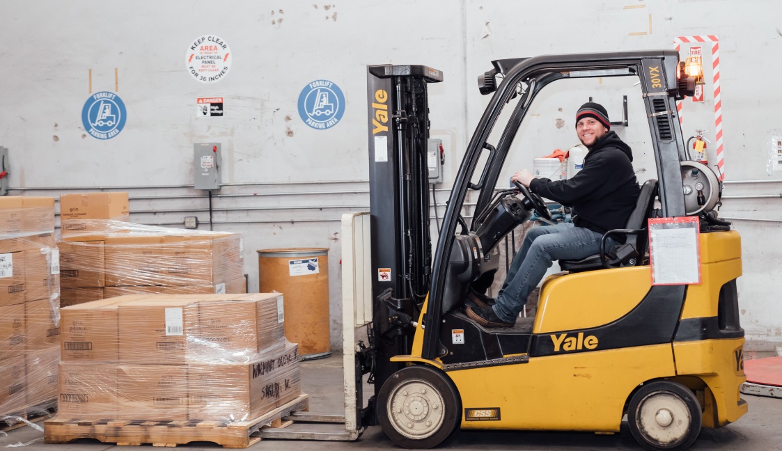 smiling on a forklift